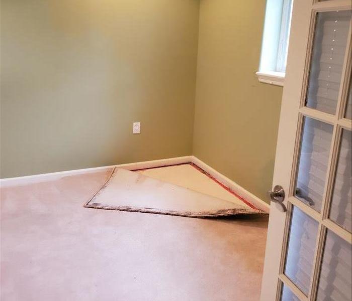 Carpet pulled up in a bedroom.